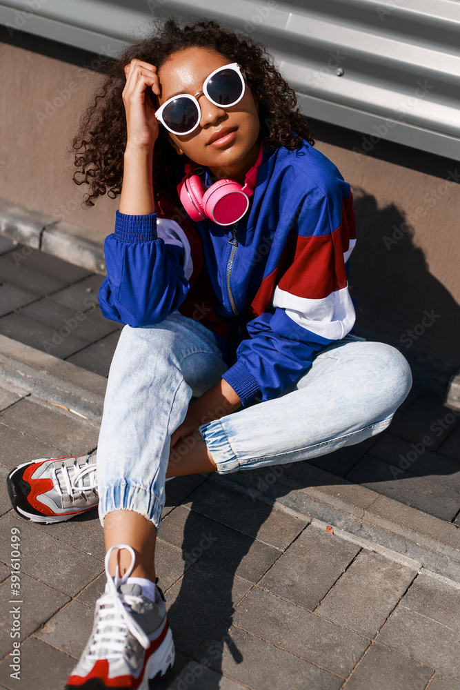 Cordelia Konvention Perth Cool black girl with curly hair, glasses, 90s, 80s, retro hip hop style,  dancing against a metal wall, dynamics and expression Stock-foto | Adobe  Stock