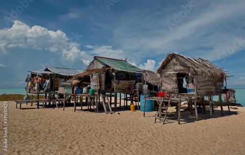 East Malaysia. Sea Gypsy village on a sandy coral reef island. The main trade of local residents is fishing and sea Souvenirs