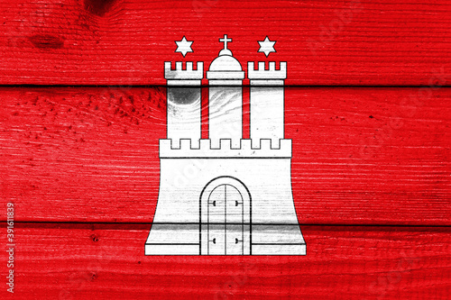 Hamburg flag painted on old wood plank background. Brushed natural light knotted wooden board texture. Wooden texture background flag of Hamburg