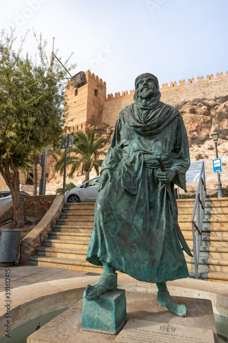 Spain; Nov 2020: Sculpture of Jayran al-Amiri, the first Arab king of Almería in front of the Alcazaba citadel, city walls with defensive towers built in Almería, Andalusia, South Spain
