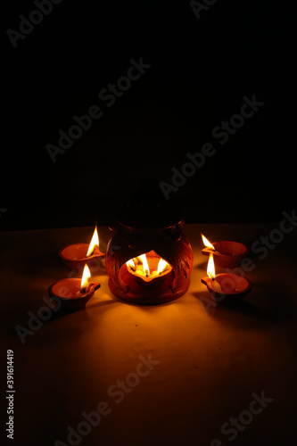 Happy Diwali diya, Diwali celebration with lights, Oil lamp on traditional tray, Clay diya.  Diya lamps lit during diwali celebration, beautiful diwali lighting
