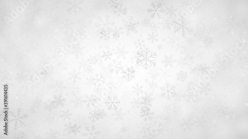 Christmas background of snowflakes of different shapes, sizes and transparency in gray and white colors