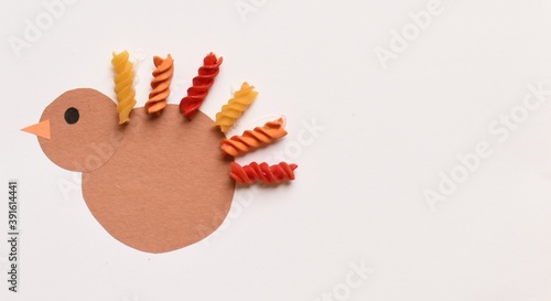 Cute Thanksgiving Turkey Craft for Kids with Macaroni Noodles Paper White Copy Space Easy Art Project for Children Inexpensive Simple Activity for Toddlers Colorful Fun Cheap Creative Idea for Moms photo