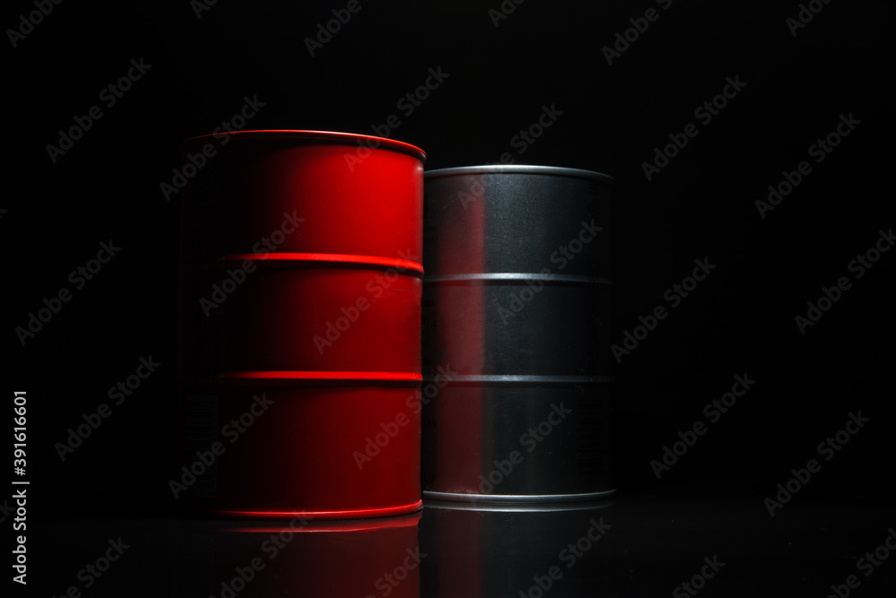 Red and metall barrel of oil on a black background. Red and metall barrel of oil on a black background.