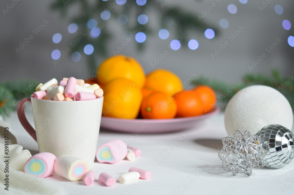 Marshmallows, tangerines and Christmas ball on bokeh background. Marshmallows, tangerines and Christmas ball on bokeh background.