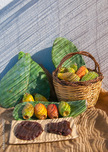 Prickly pears and sicilian mostarda on a table with a wicker basket