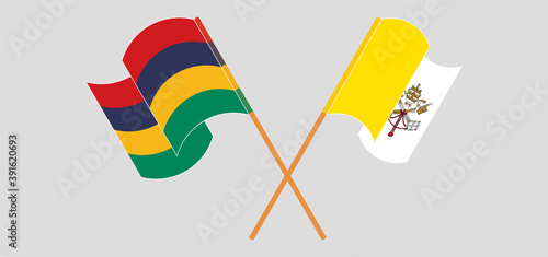 Crossed and waving flags of Vatican and Mauritius