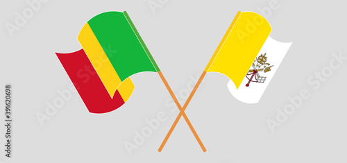 Crossed and waving flags of Vatican and Mali