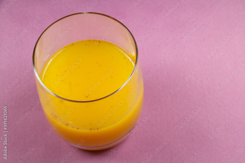 Glass of punch with rum, orange juice and spices Glass of punch with rum, orange juice and spices