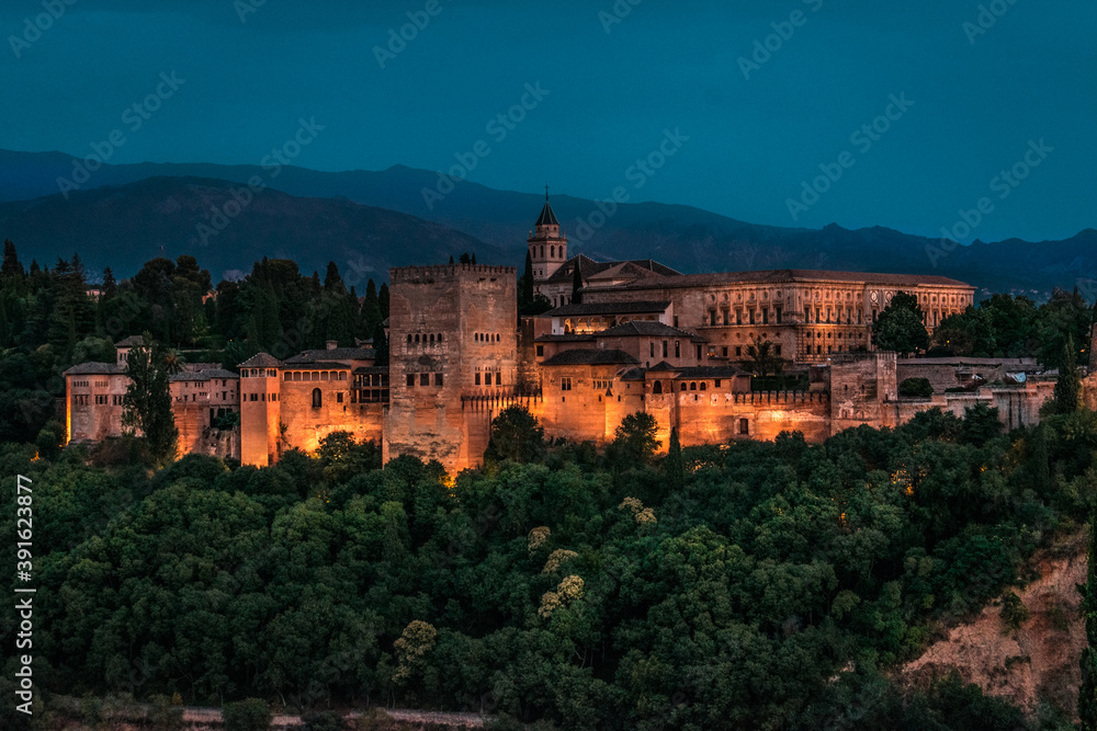 The Alhambra in Granada during a sunset with beautiful views of the city at its best, articulating the landscape with incredible architecture.