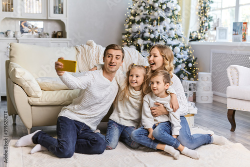 happy family taking selfie picture with smartphone at Christmas