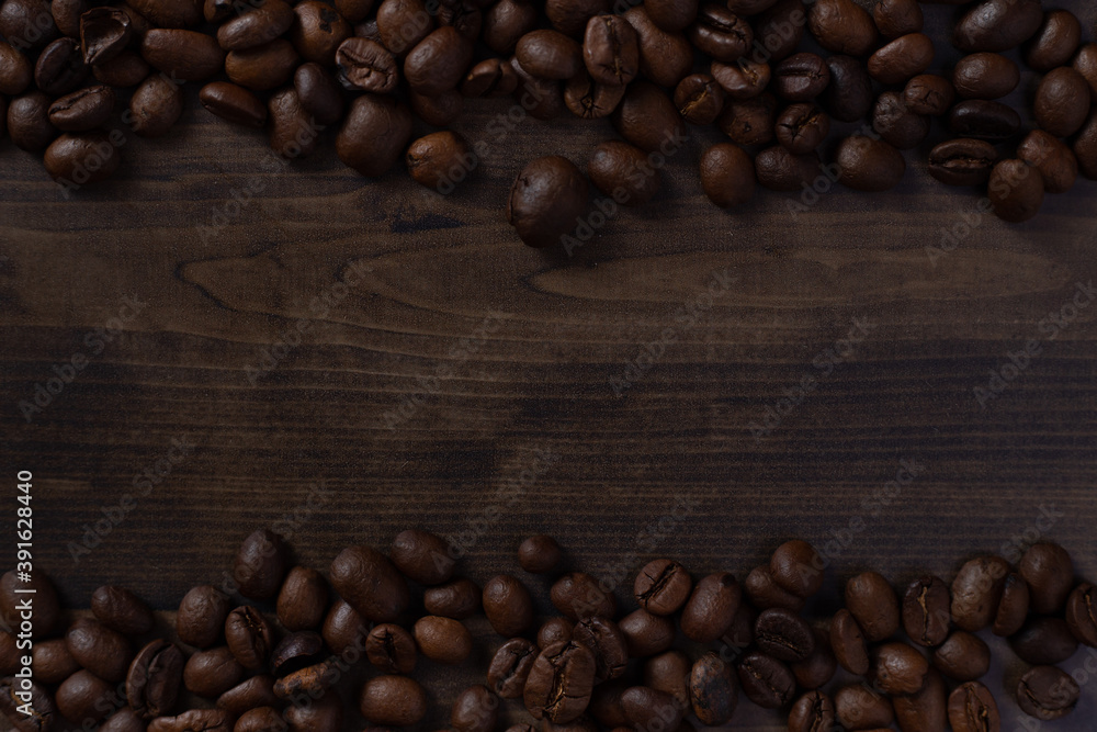 Close up of scattered coffee beans on wooden table Close up of scattered coffee beans on wooden table
