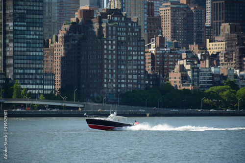 Fototapeta Naklejka Na Ścianę i Meble -  New York, USA - June 3, 2019: View on the speed boat from Gantry Plaza State Park in Queens