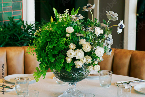 Fototapeta Naklejka Na Ścianę i Meble -  elegant dining table set with flower bouquet