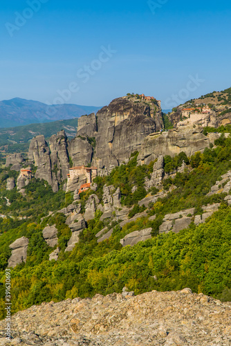 Beautiful vertical view of the monasteries (Varlaam, Rousanou, St. Nicolaus, an Great Meteoron) of Meteora, Thessaly, Greece with spectacular unique rock formations