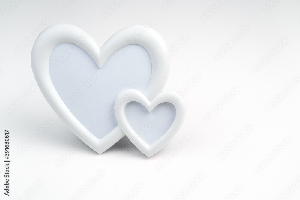 Background for February 14, frame of two white hearts on a light background. Side view with space for copying. Concept for lovers. Background for February 14, frame of two white hearts on a light background. Side view with space for copying. Concept for lovers.