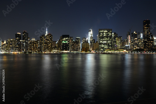 NEW YORK CITY - JUNE 26, 2019: Night view to Manhattan skyline from Gantry Plaza State Park