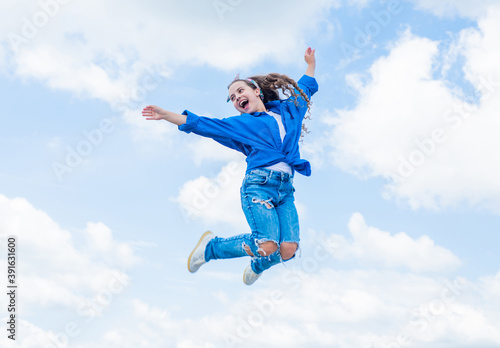 Fashion is her life. teen girl jumping high in the sky. having a party fun. Happy kid wear shirt. Lifestyle and People Concept. kid spring and fall fashion. full of energy. childhood happiness