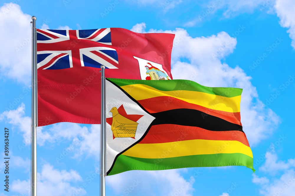 Zimbabwe and Bermuda national flag waving in the windy deep blue sky. Diplomacy and international relations concept. Zimbabwe and Bermuda national flag waving in the windy deep blue sky. Diplomacy and international relations concept.