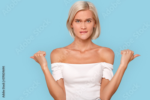 Young adult girl showing fingers aside, making choice