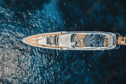 Aerial view of yacht in blue sea with helipad, Saint Tropez, France.