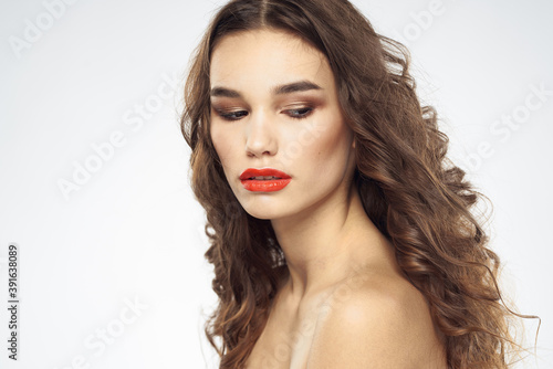 Beautiful woman with drawn swords bright makeup glamor close-up light background