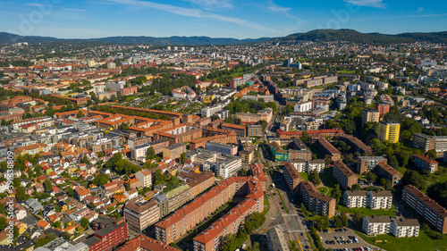 Oslo, Norway. Beautiful panoramic aerial view photo from flying drone for Oslo city new neighborhoods and new homes. Against the background of the mountains and blue sky on a sunny summer day. (Series
