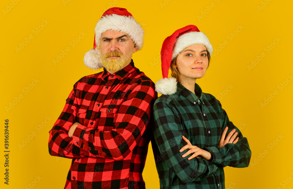 We love christmas. Couple in love enjoy christmas holiday celebration. Family wear santa hats. Entertainment ideas for adults. Santa team. Loving couple yellow background. Christmas magical time We love christmas. Couple in love enjoy christmas holiday celebration. Family wear santa hats. Entertainment ideas for adults. Santa team. Loving couple yellow background. Christmas magical time