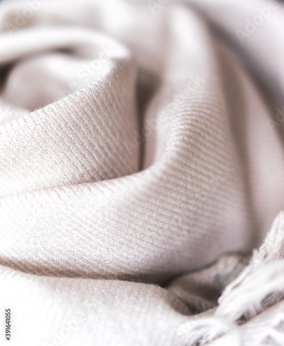 close up of a cashmere scarf, pink fabric, piece of clothing, woolen texture, clothing material, soft pink blanket