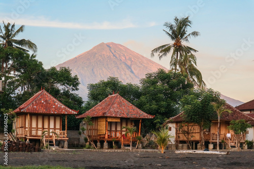 Traditional balinese wooden bungalows on beach photo