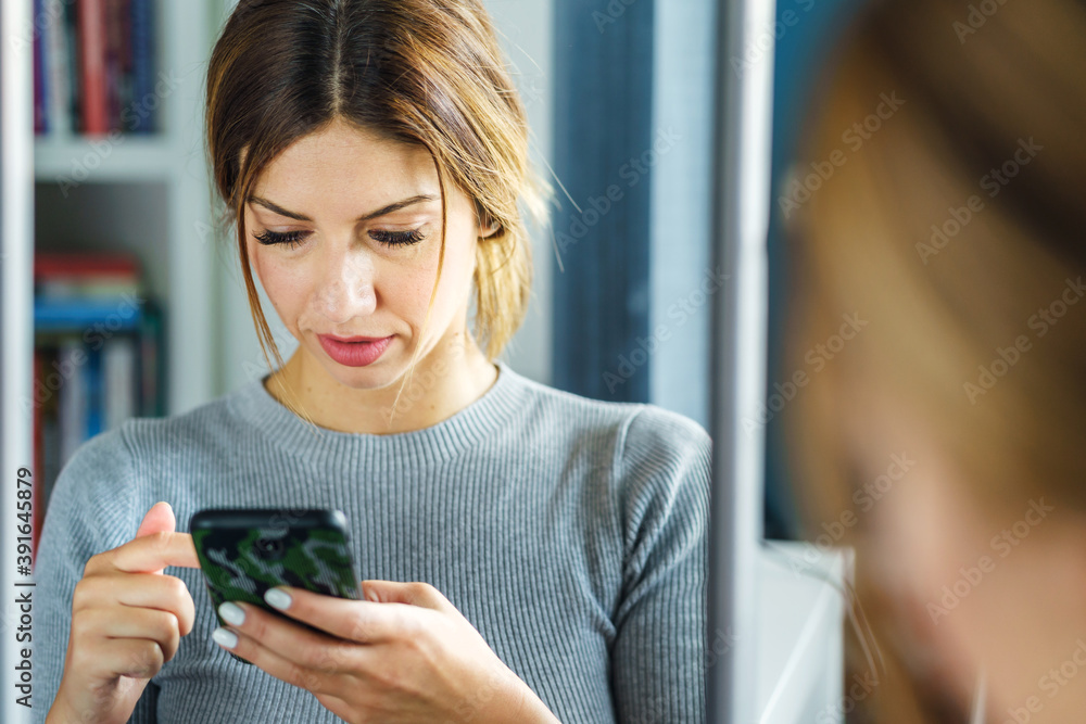 Adult caucasian woman using mobile phone to browse internet or send text message Adult caucasian woman using mobile phone to browse internet or send text message