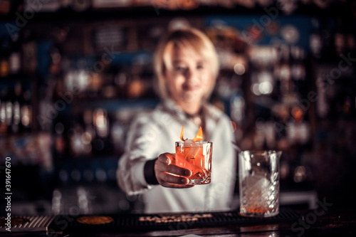 Girl bartender makes a cocktail in the beerhall photo