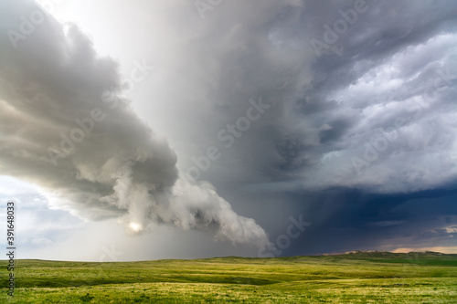 Scenic landscape with rolling hills and storm clouds in Montana