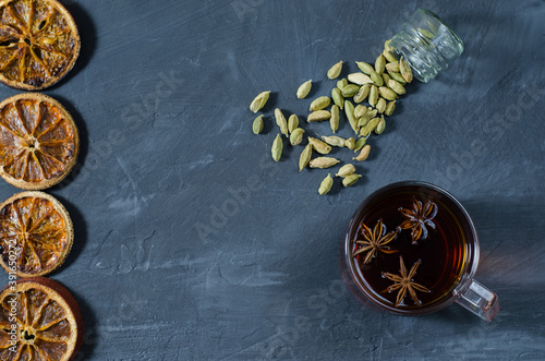 Top view to a cup of tea with dried orange slices and capers and badian © Denius