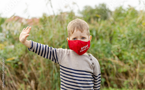 Cute boy protect spreading of disease virus with wearing mask