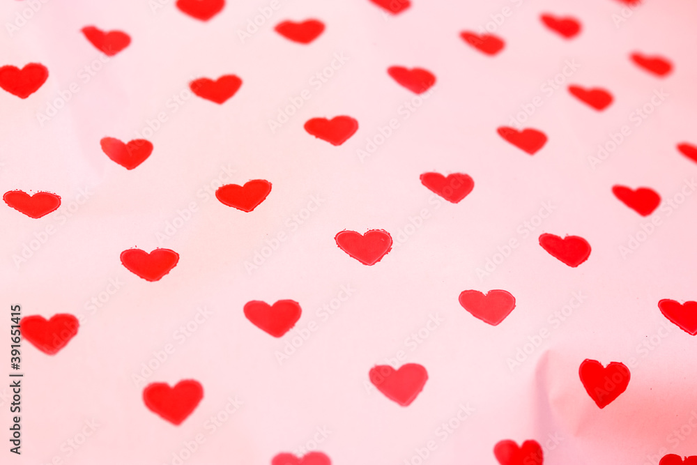 Festive background on Valentine's Day or Valentine's Day, red little hearts on white background. Gift paper close-up