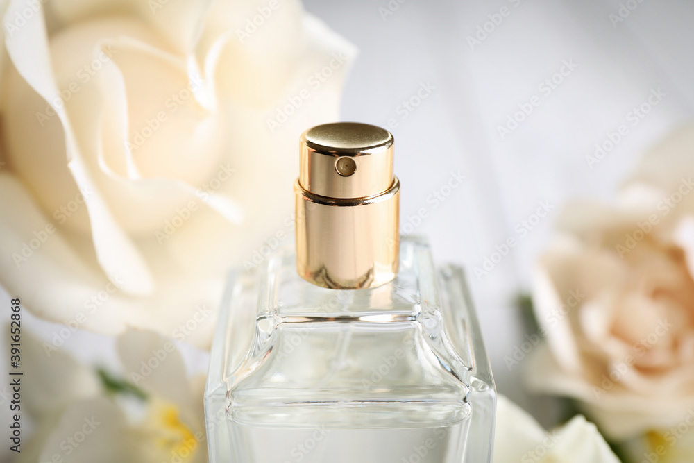 Bottle of perfume on blurred background, closeup Bottle of perfume on blurred background, closeup