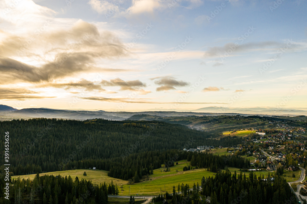 Drone landscape of polish mountain city right next to the big forest