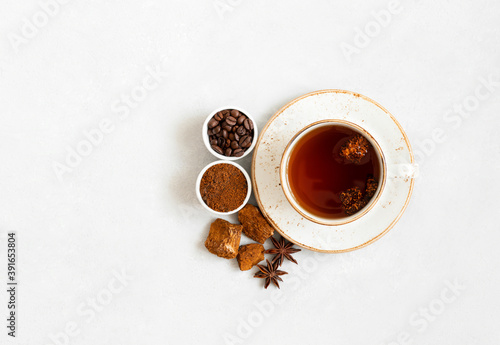 Cup with mushroom chaga drink and coffee on a white background. Trendy superfood. Space for text. Top view, flat lay.