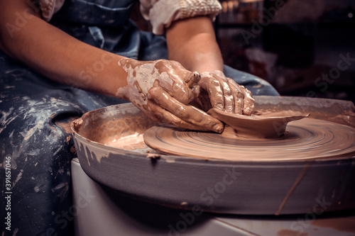 Craftsmen sculpts from clay. Craft manufacture. Close-up. photo