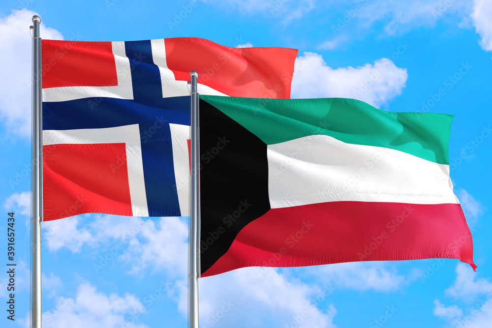 Kuwait and Bouvet Islands national flag waving in the windy deep blue sky. Diplomacy and international relations concept. Kuwait and Bouvet Islands national flag waving in the windy deep blue sky. Diplomacy and international relations concept.