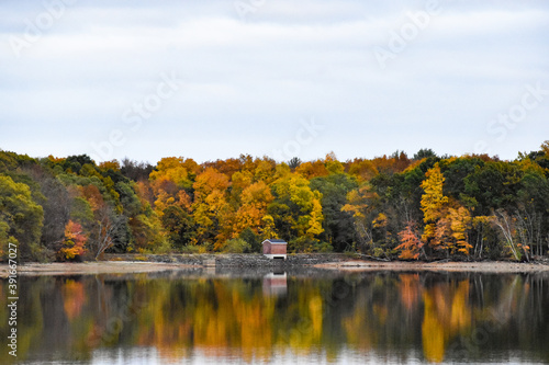 Small pump house on a reservoir in the fall