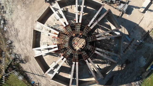 Aerial shot of workers in a construction, structure in the process to be build