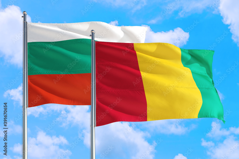 Obraz premium Guinea Bissau and Bulgaria national flag waving in the windy deep blue sky. Diplomacy and international relations concept.