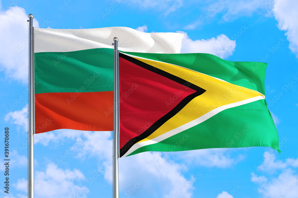 Guyana and Bulgaria national flag waving in the windy deep blue sky. Diplomacy and international relations concept. Guyana and Bulgaria national flag waving in the windy deep blue sky. Diplomacy and international relations concept.