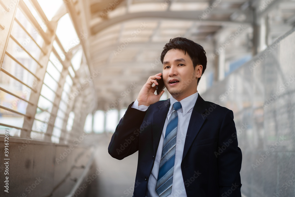 successful business man in suit talking a mobile phone in city successful business man in suit talking a mobile phone in city