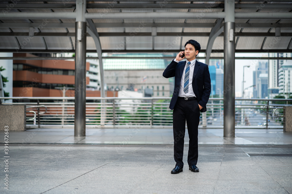 successful business man in suit talking a mobile phone in city successful business man in suit talking a mobile phone in city