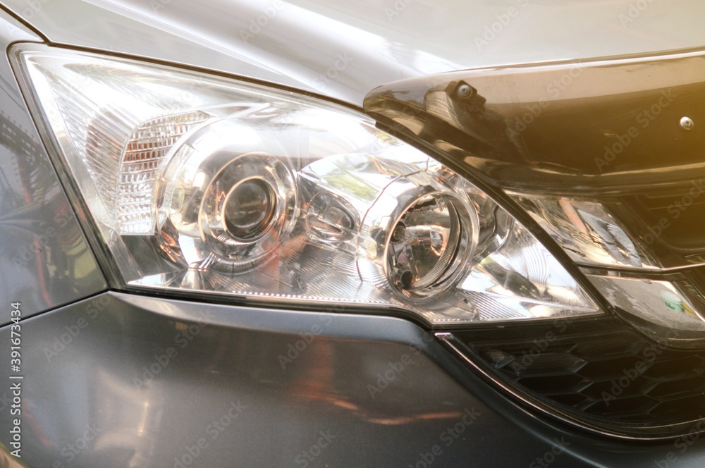 Big headlight cleaning on the car with power buffer machine at service station,Before and after