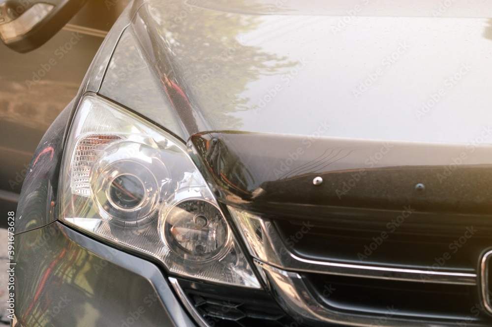 Big headlight cleaning on the car with power buffer machine at service station,Before and after