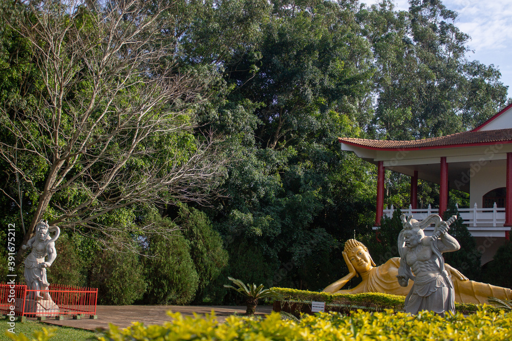 Statue of warrior and Budha in the garden in Foz do Iguaçú